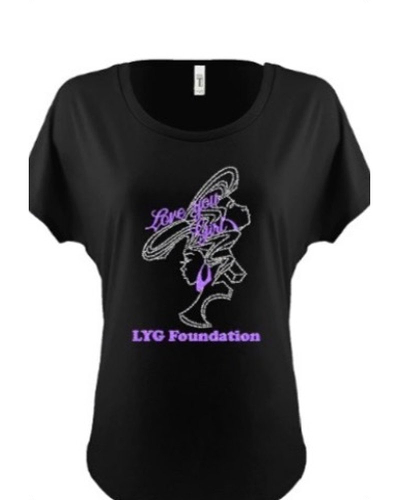 Black t-shirt printed with the Love You Girl logo in purple vinyl above the words LYG Foundation
