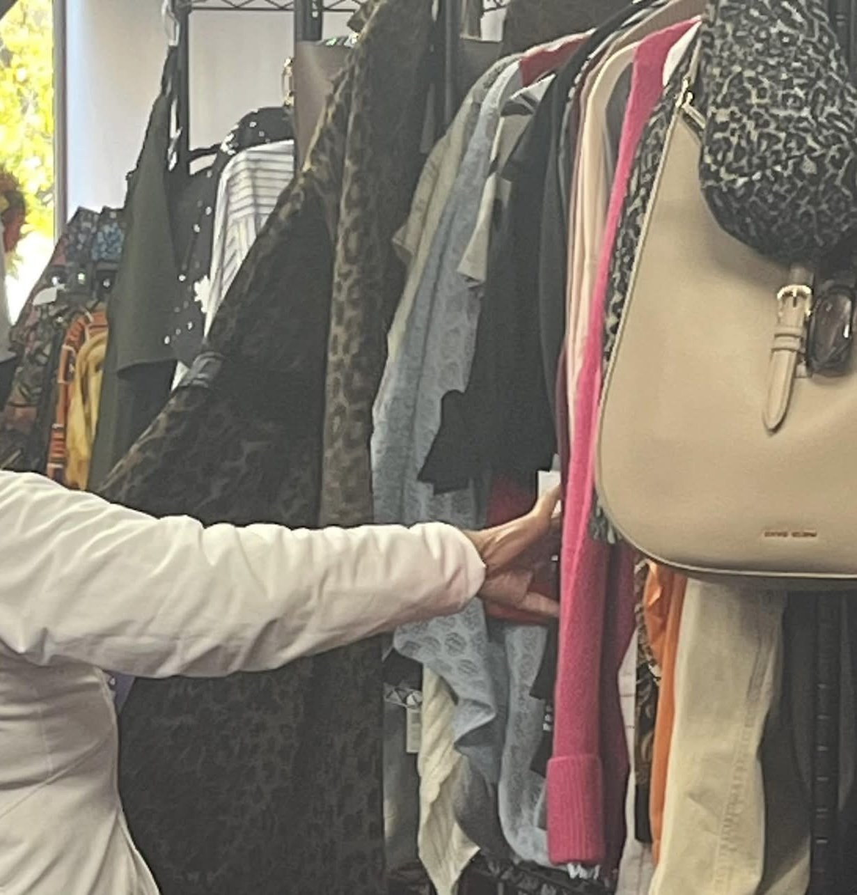 A visitor looking through clothing at a Love You Girl Foundation event